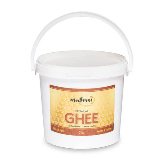 Jar of Modhani Desi Ghee made from clarified butter, featuring traditional packaging ideal for Indian cooking, baking, frying, and enhancing flavor in meals.
