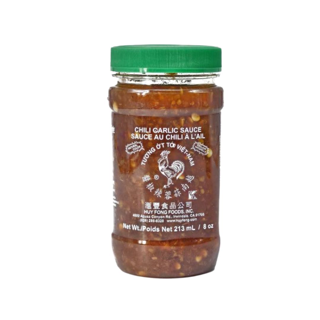 Chunky red chili garlic sauce with visible seeds and garlic bits for authentic flavor