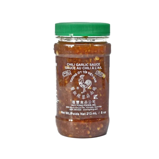 Chunky red chili garlic sauce with visible seeds and garlic bits for authentic flavor