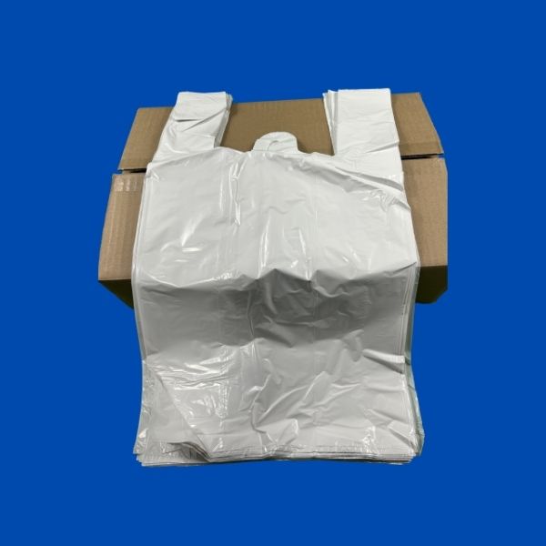 A single, large, crumpled white plastic t-shirt style shopping bag, shown from the front with handles extended, isolated against a blue background