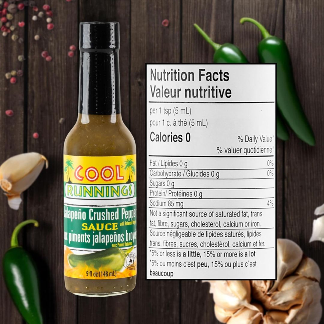 Green jalapeño sauce bottle surrounded by fresh peppers and garlic