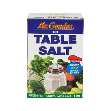 A 1kg blue and white box of Mr. Goudas Iodized Table Salt featuring a shaker and fresh vegetables.