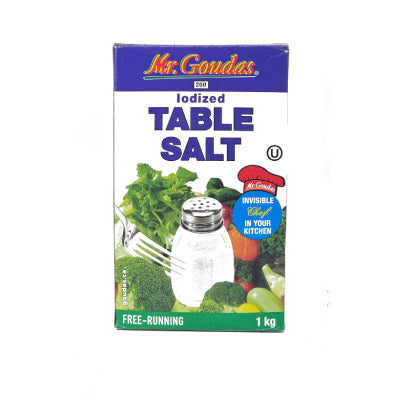 A 1kg blue and white box of Mr. Goudas Iodized Table Salt featuring a shaker and fresh vegetables. Front view of free-running table salt 1kg box showing the invisible chef logo. Premium iodized salt for professional kitchen use and bulk food service.